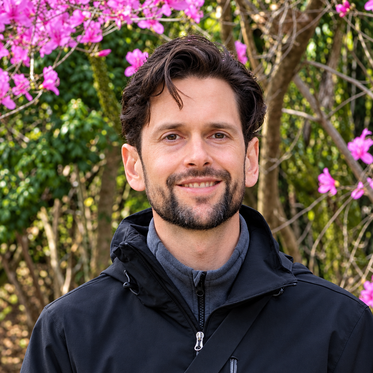 Daniel I Stein outdoors beside flowering trees
